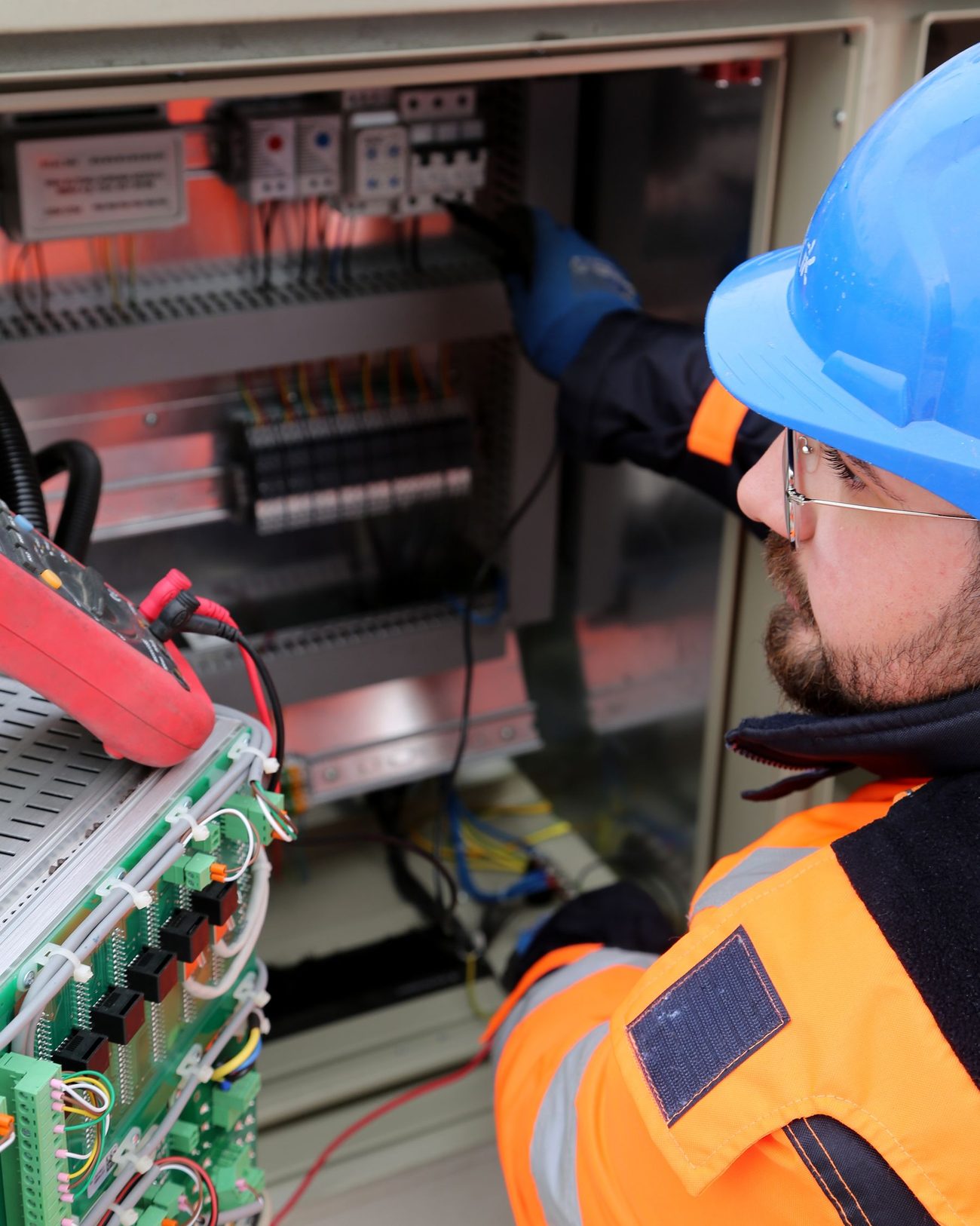 An electrician working on a switchboard